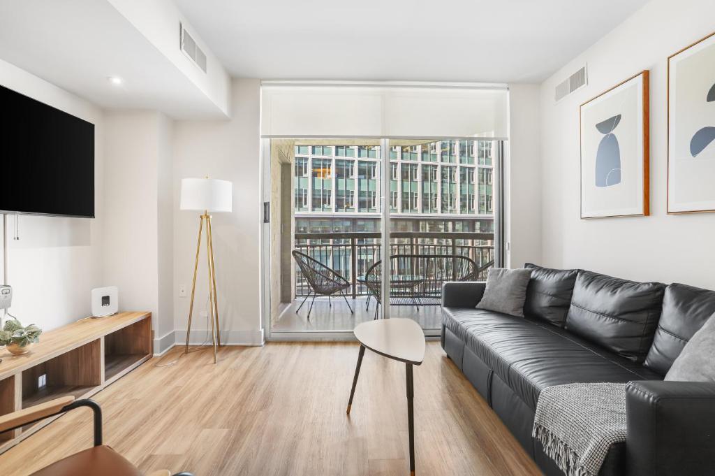 a living room with a couch and a table at Comfortable Apartment with Top Amenities in Arlington