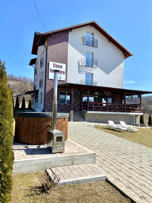 a building with a tv in front of it at Casa Dumitru in Ceraşul