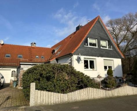 a white house with a red roof at Ferienwohnung Dachstübchen in Bad Lauterberg