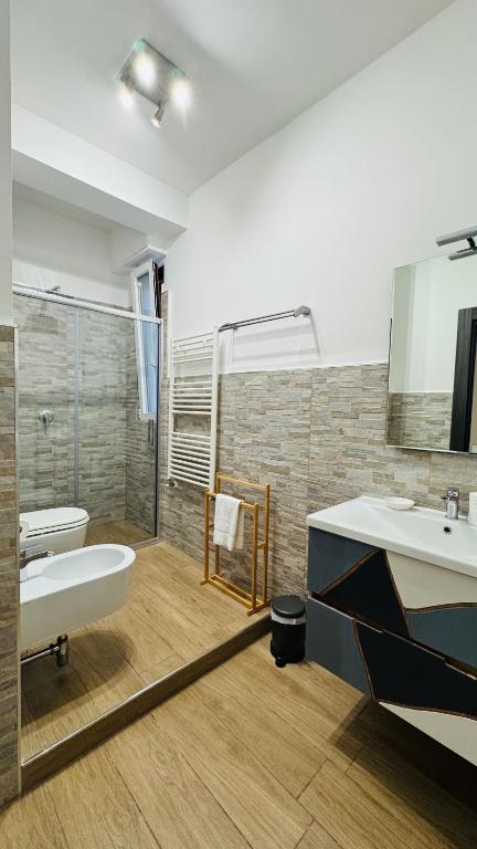 a bathroom with a tub and two sinks and a shower at Cala Portavecchia in Monopoli