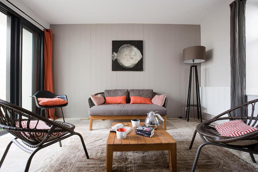 un salon avec un canapé et deux chaises dans l'établissement Chai RHETAIS, au Bois-Plage-en-Ré