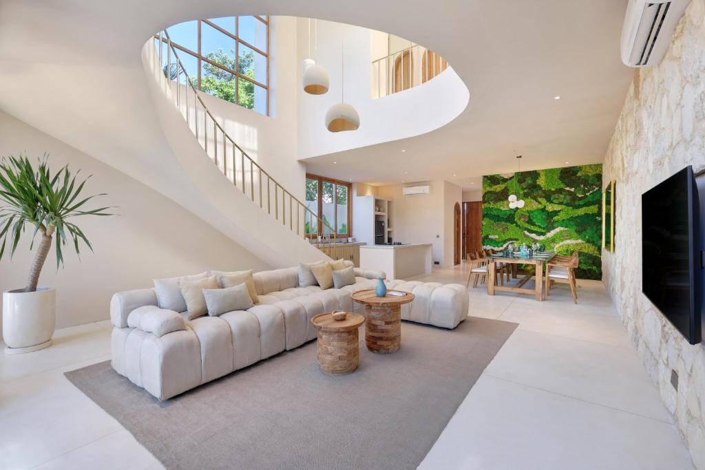 a living room with a white couch and a fireplace at 2 Bedroom Entire Place Villa Harmony Uluwatu Bingin in Uluwatu