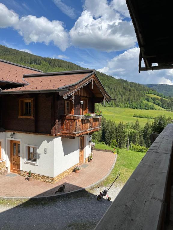 a view of a house from the wing of an airplane at Bauernhütte Niedermaisgut in Eben im Pongau