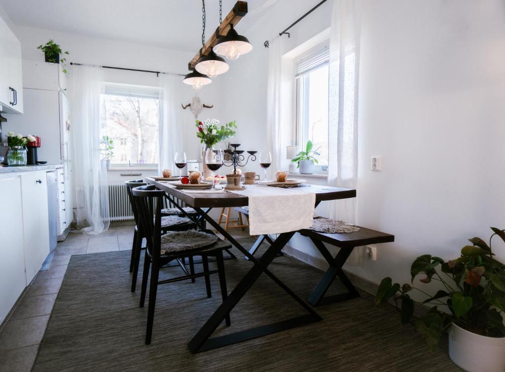a kitchen with a dining room table with chairs at HaHa Nordic Home Partille Spacious 2BR Apartment near Center with Garden & Parking in Gothenburg