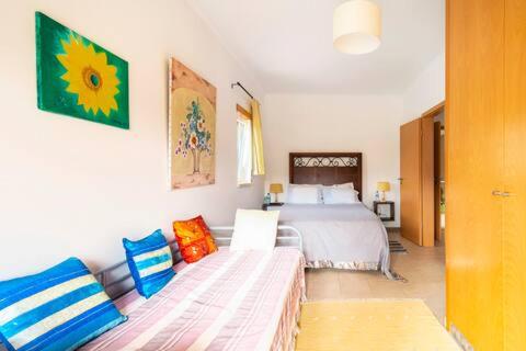 a bedroom with a bed and a couch and a bed at Beco do Patalugo in Salir de Matos