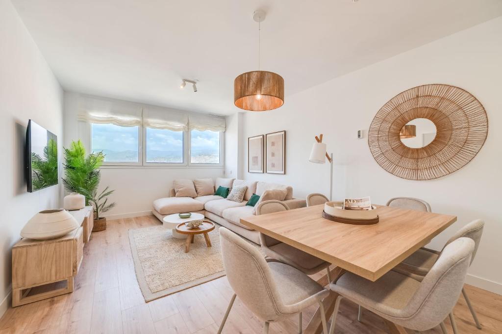a living room with a table and a couch at Sky Urban Tower in Málaga