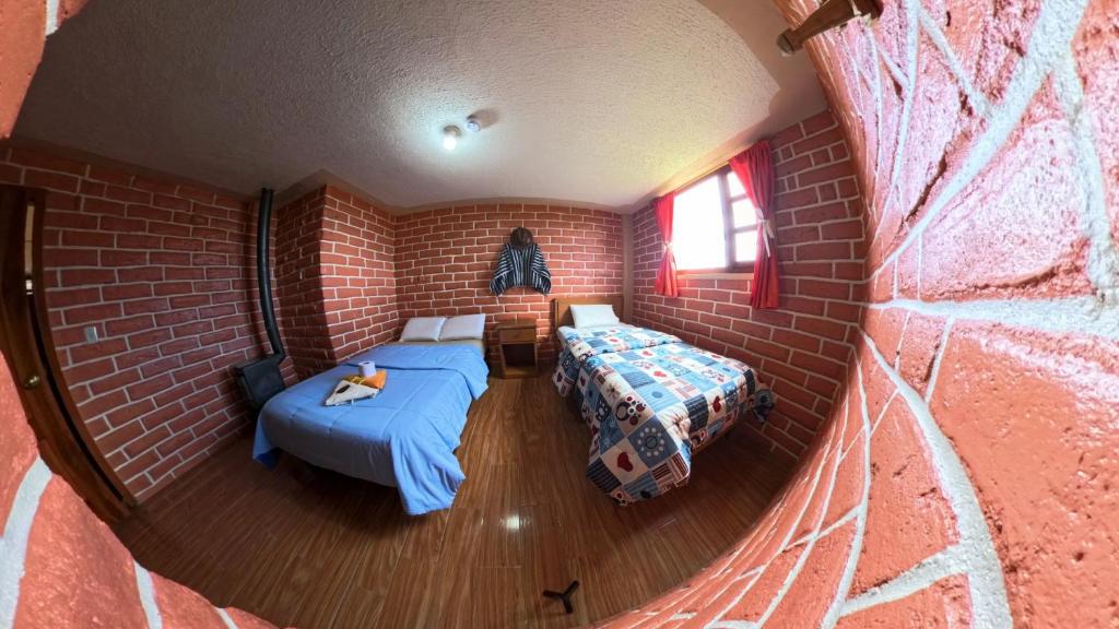 Postel nebo postele na pokoji v ubytování Runa Wasi Quilotoa