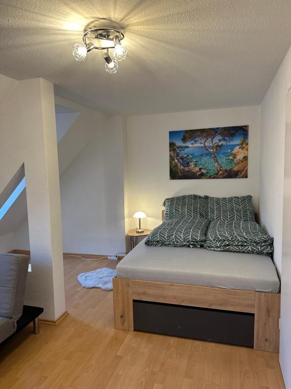 a bedroom with a bed and a painting on the wall at Linda Ninh Apartment 6 Altstadt in Dresden