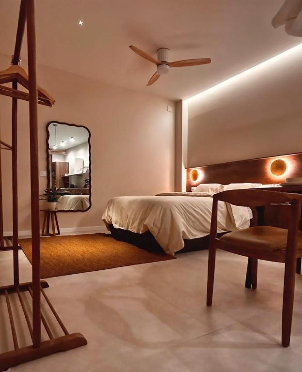 a bedroom with a bed and a table and a mirror at Pivote Flats-Playa B in Valencia