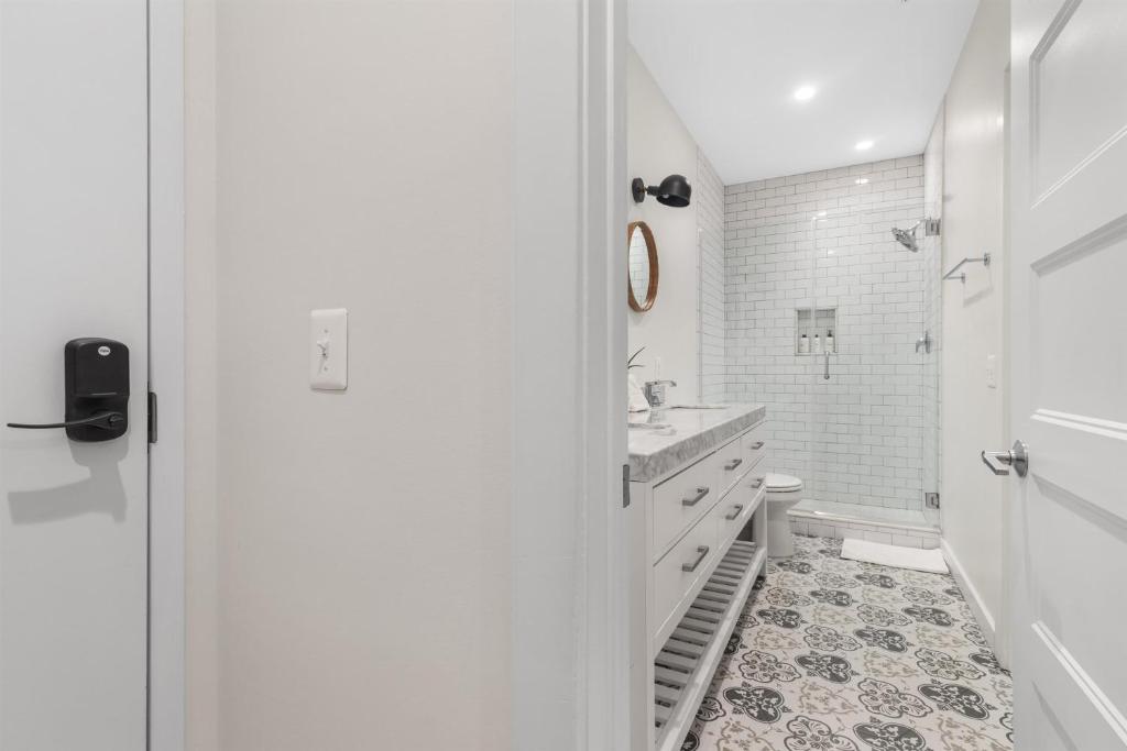 a white bathroom with a sink and a toilet at 1-BR Getaway in the Heart of Adams Morgan in Washington, D.C.