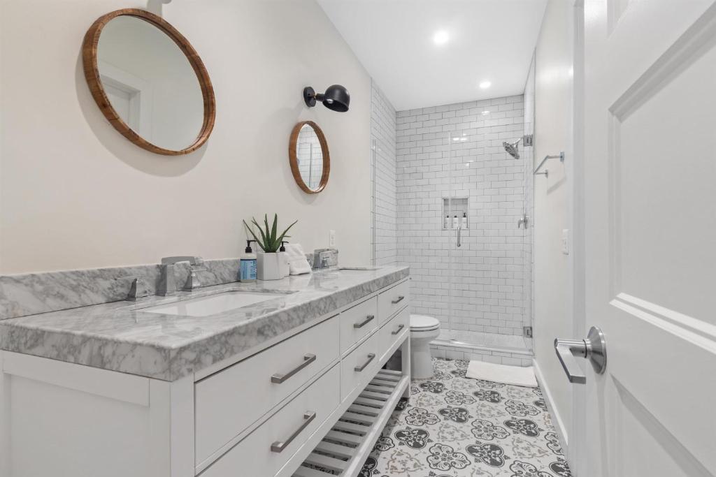 a white bathroom with a sink and a toilet at 1-BR Getaway in the Heart of Adams Morgan in Washington, D.C.