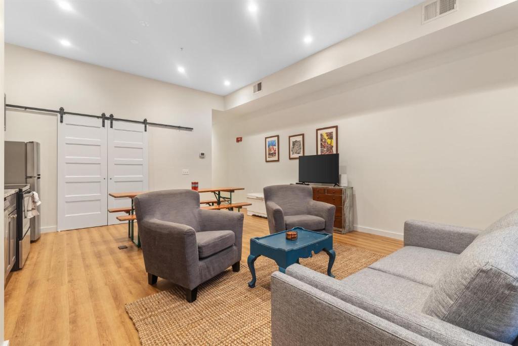 a living room with a couch and two chairs and a table at Heart of Adams Morgan Walk Everywhere in Washington, D.C.