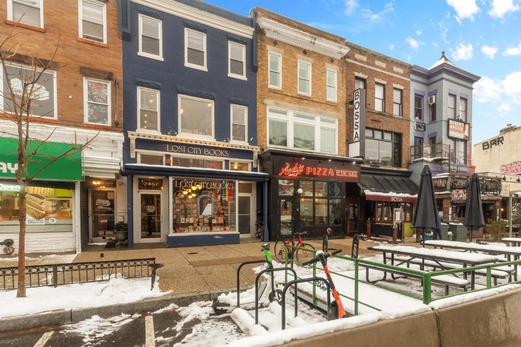 a city street with shops and snow covered sidewalks at Live Like a Local in the Heart of Adams Morgan in Washington, D.C.