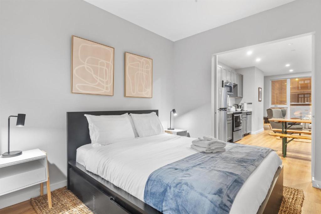 a bedroom with a large bed and a living room at Live Like a Local in the Heart of Adams Morgan in Washington, D.C.