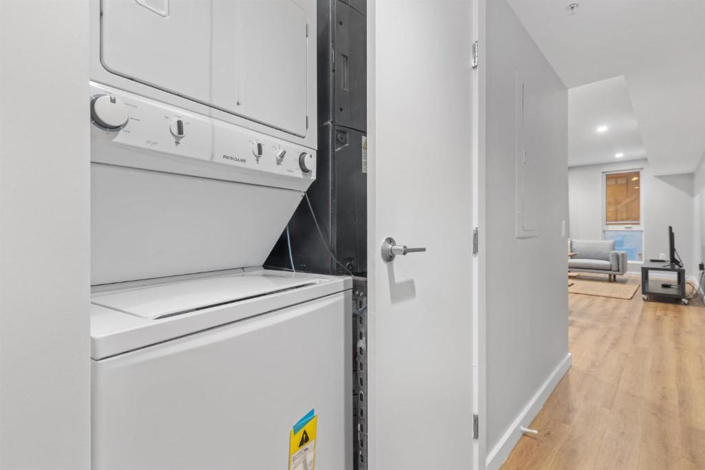 a kitchen with white cabinets and a refrigerator at Live Like a Local in the Heart of Adams Morgan in Washington, D.C.