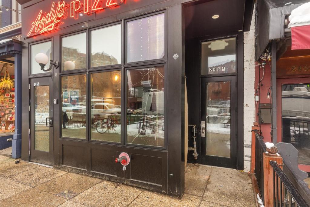 a store front with glass doors on a street at Live Like a Local in the Heart of Adams Morgan in Washington, D.C.