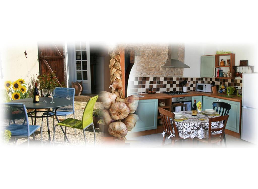 a kitchen and dining room with a table and chairs at La Greletterie in Champagné-le-Sec