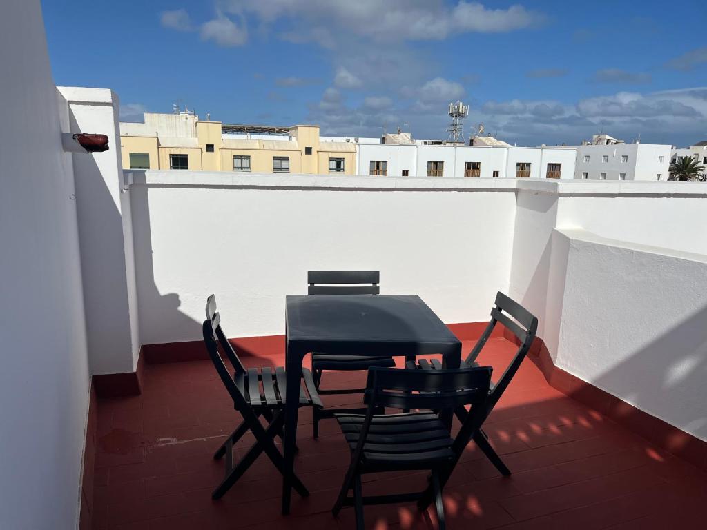 a table and chairs sitting on a balcony at Margarita House in Arrecife