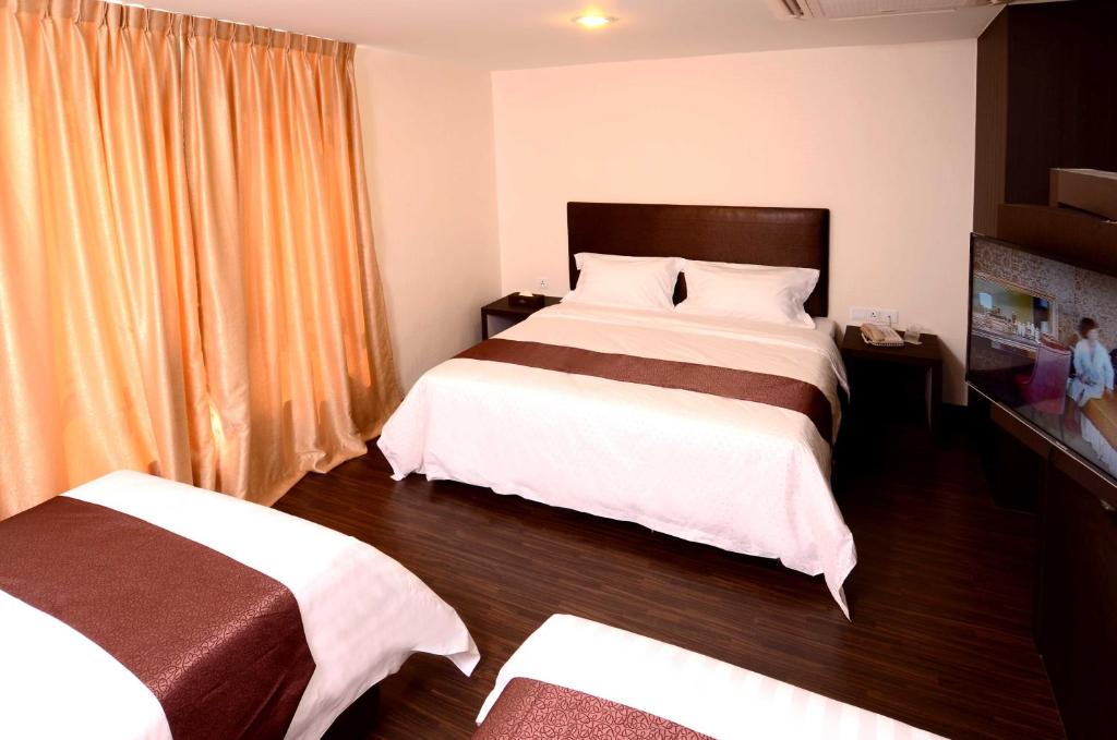 Postel nebo postele na pokoji v ubytování Hotel Nusa CT