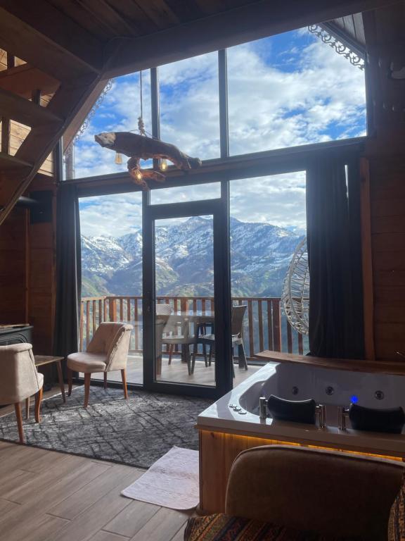 a kitchen with a large window with a view of mountains at 101 nolu oda in Çamlıhemşin