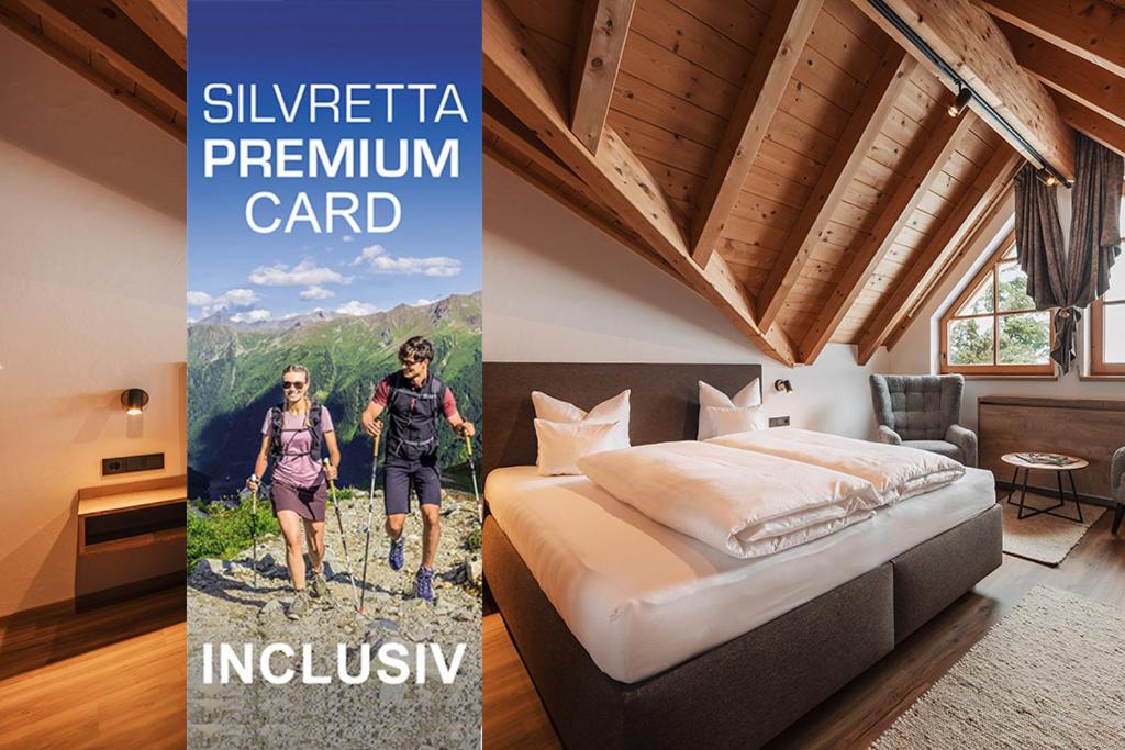 a hotel room with a bed and a picture of two people at Ischgl Panorama in Kappl