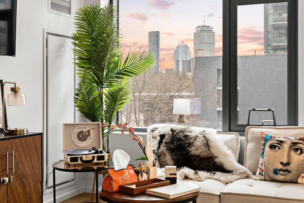 a living room with a couch and a palm tree at Family Friendly Boston Suite in Cambridge
