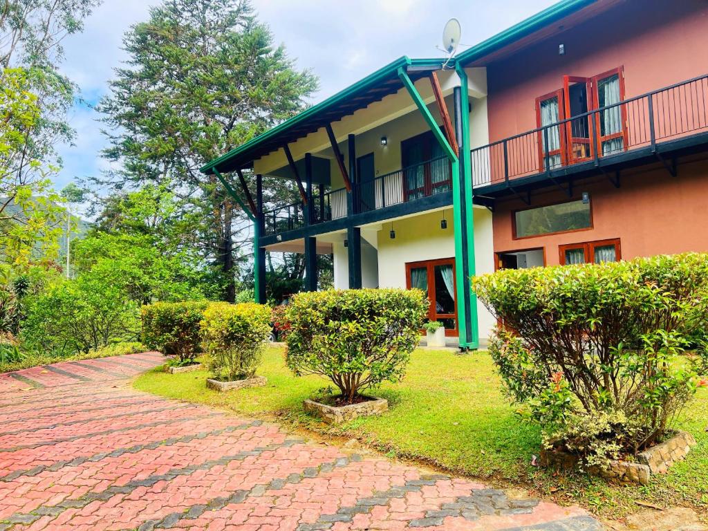 a house with a brick path in front of it at Agarapathana Estate Holiday Bungalow in Hatton