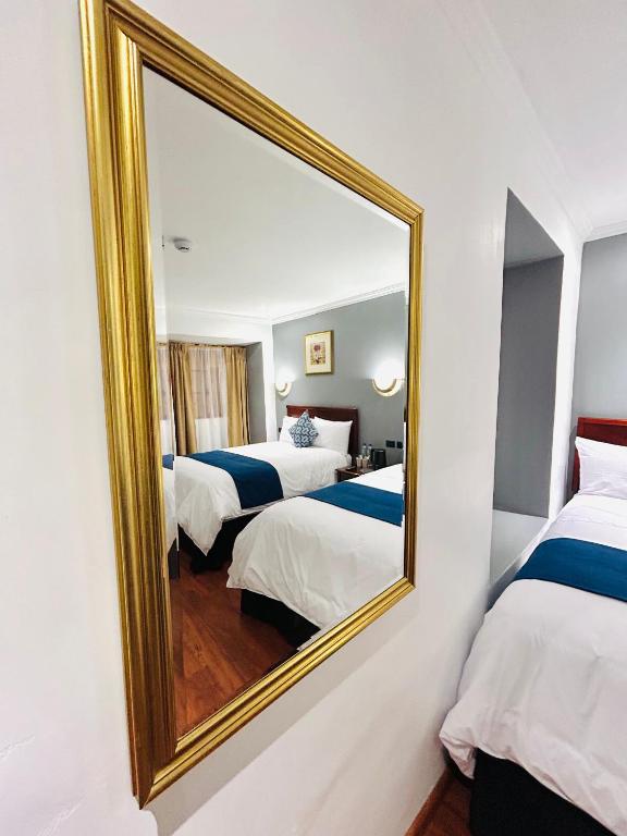 Postel nebo postele na pokoji v ubytování ACCEL Hotel Casa Nueva