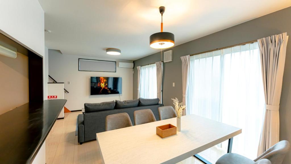 a living room with a couch and a table at Homey Inn in Kyoto