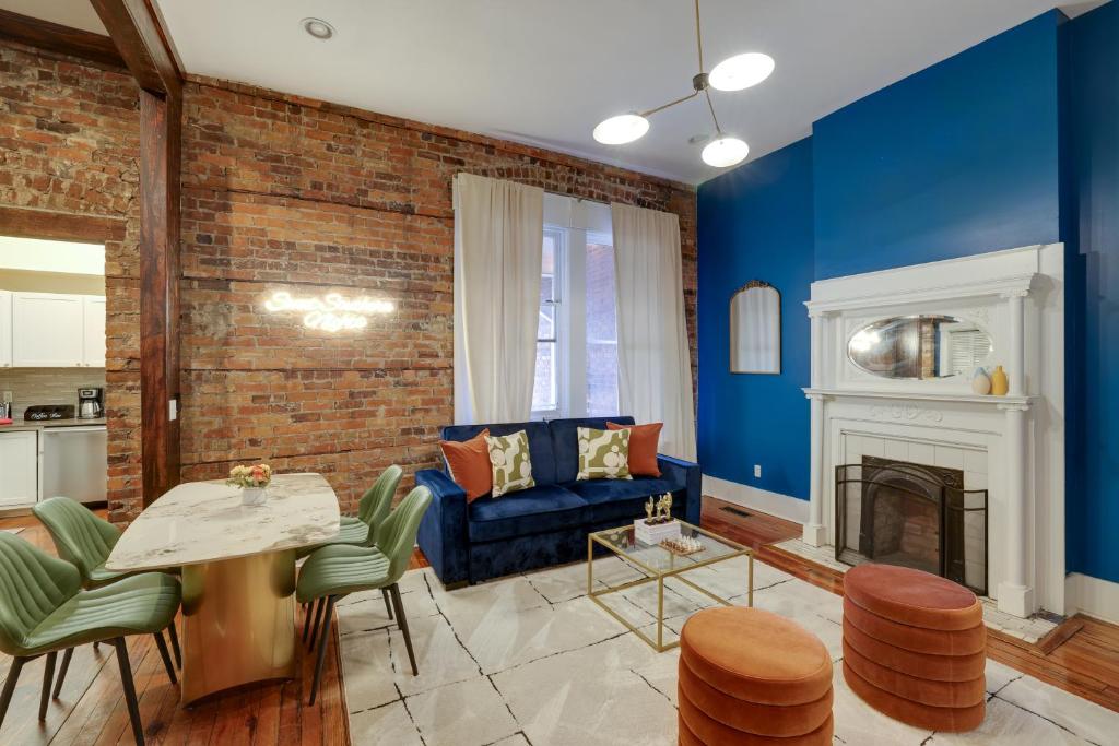 a living room with a blue couch and a fireplace at Mid-Century getaway in Savannah