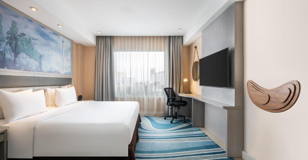 Postel nebo postele na pokoji v ubytování Mercure Jakarta Cikini