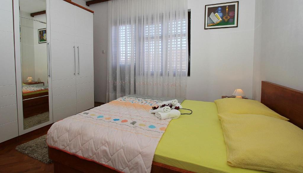 a bedroom with a bed with a toy animal on it at Apartment Adriana in Makarska