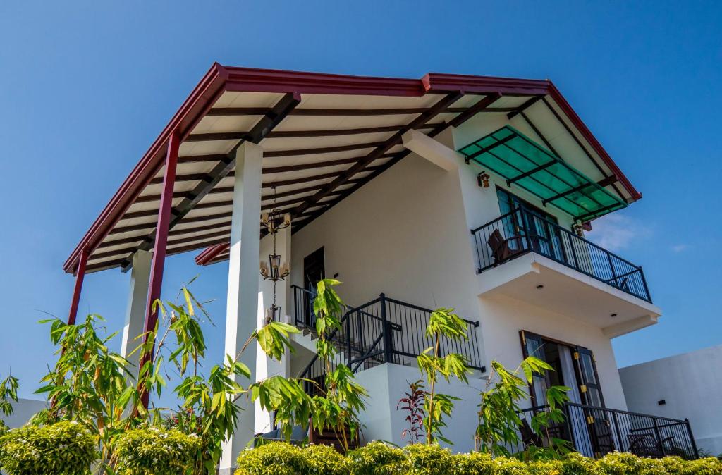 a white building with a balcony at Villa Barbara - Private Pool Villa in Ahungalla in Ahungalla