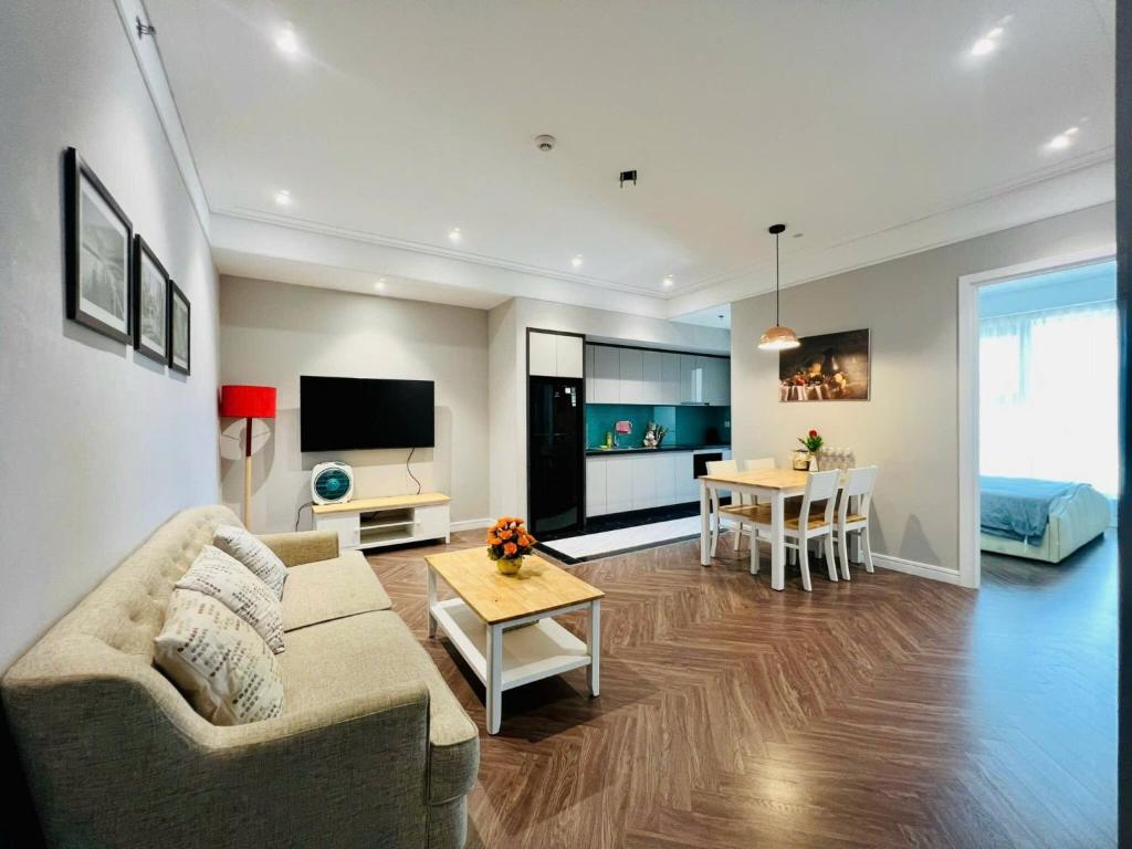 a living room with a couch and a table at CĂN HỘ ALTARA Hương vị Biển in Quy Nhon