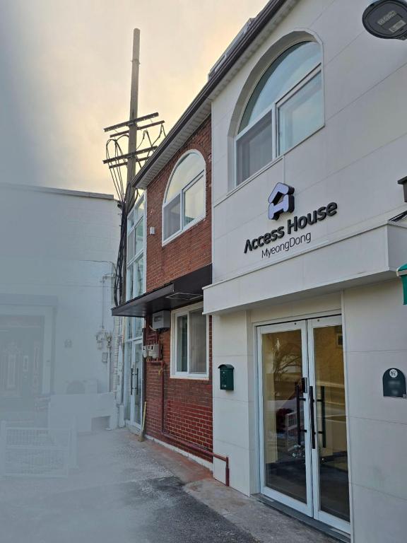 a building with aacross house on a street at AccessHouse in Seoul