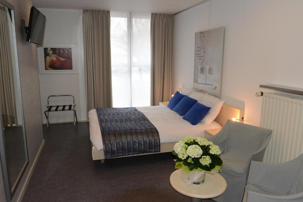 Postel nebo postele na pokoji v ubytování Hotel Vijfwegen