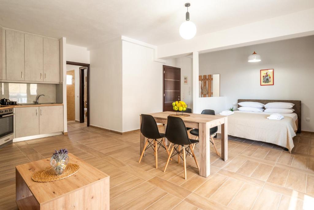 a kitchen and living room with a table and a bed at NT Studio in Igoumenitsa