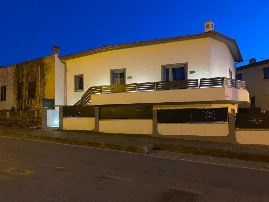 a white building with a balcony on the side of a street at Affittacamere Mary's Rooms in San Teodoro