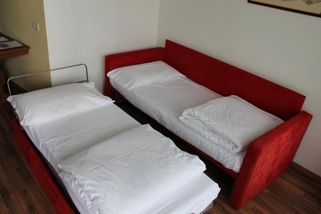 Postel nebo postele na pokoji v ubytování Hotel Baita Clementi