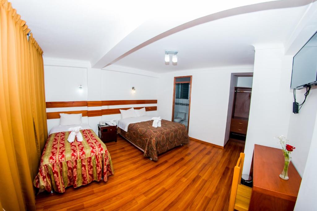 Postel nebo postele na pokoji v ubytování Hostal Los Andes