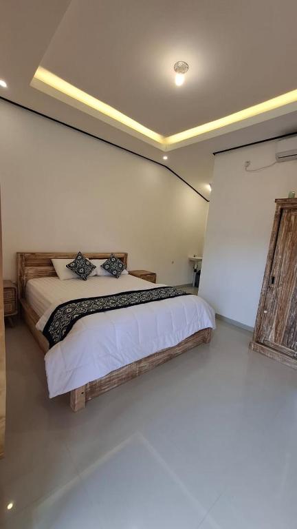 Postel nebo postele na pokoji v ubytování Raditya Homestay
