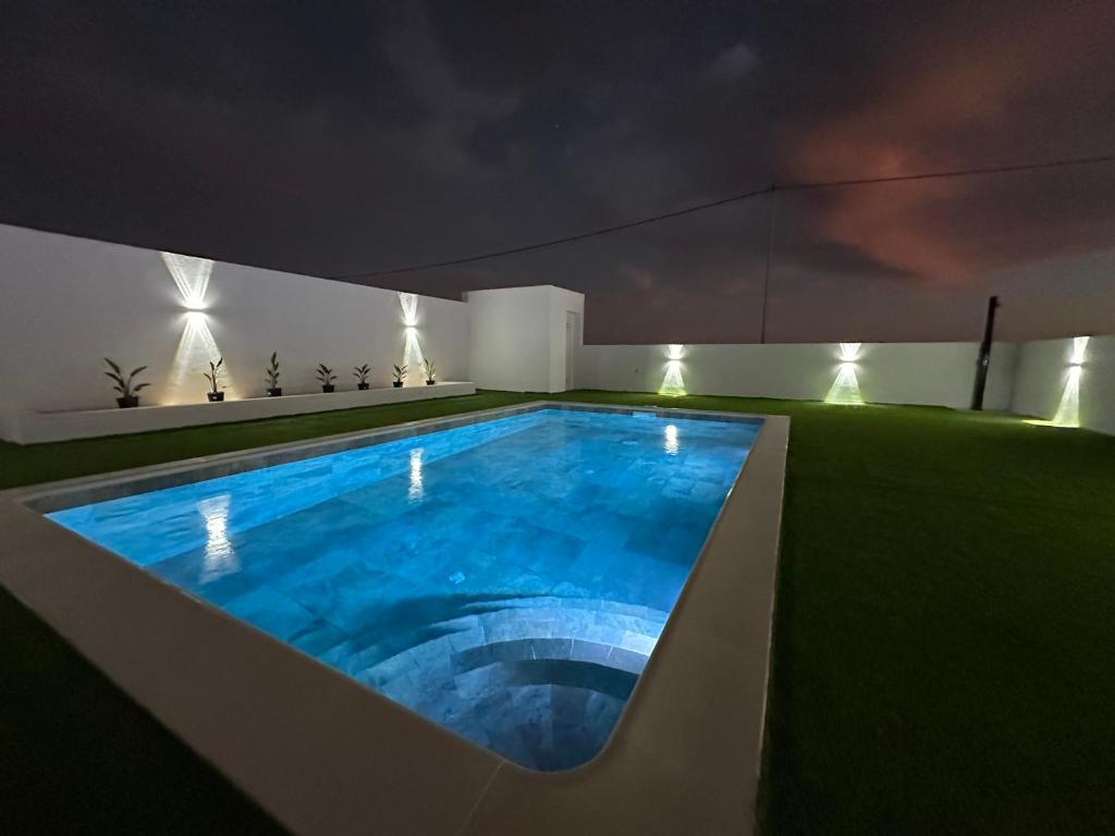 a swimming pool on the roof of a house at night at Fuerte Roche 1 in Tuineje