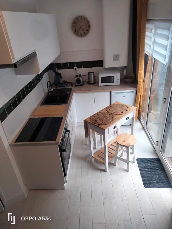 a small kitchen with a table and a counter at Appartement centre lannion in Lannion