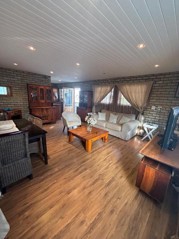 a living room with a couch and a table at 33 On Loop, Flat 3 in Ladybrand
