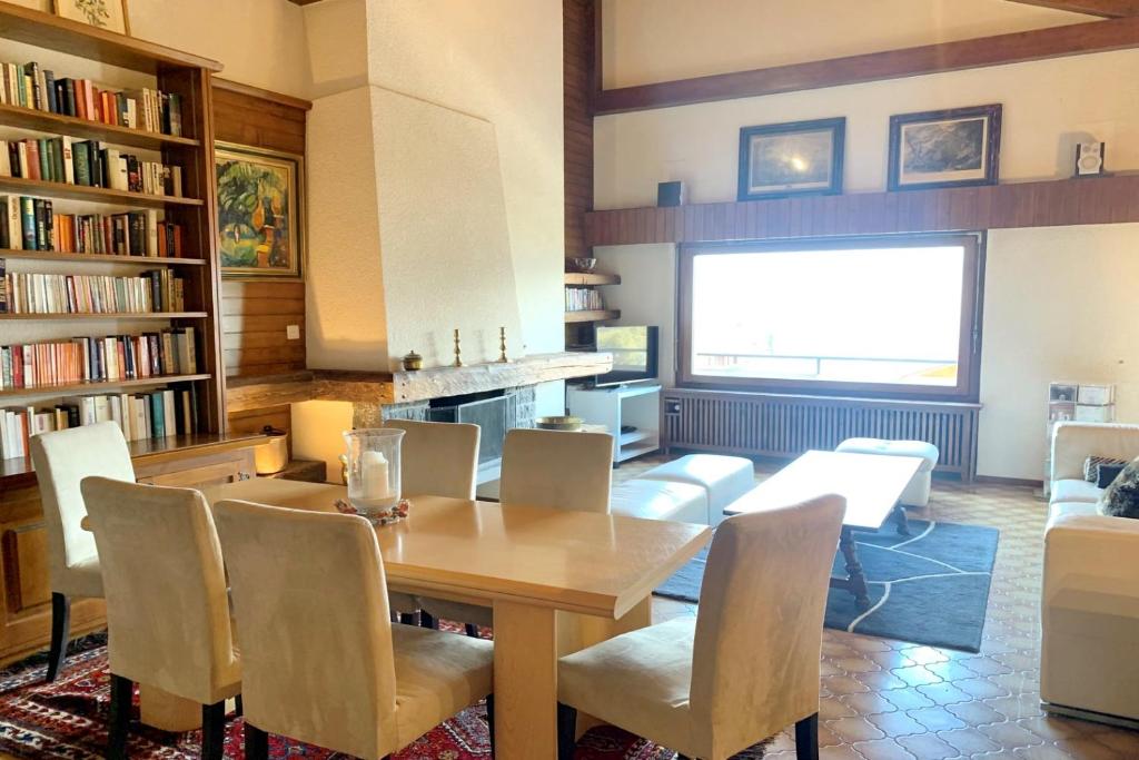 a dining room with a wooden table and chairs at Christiania 431 in Bagnes