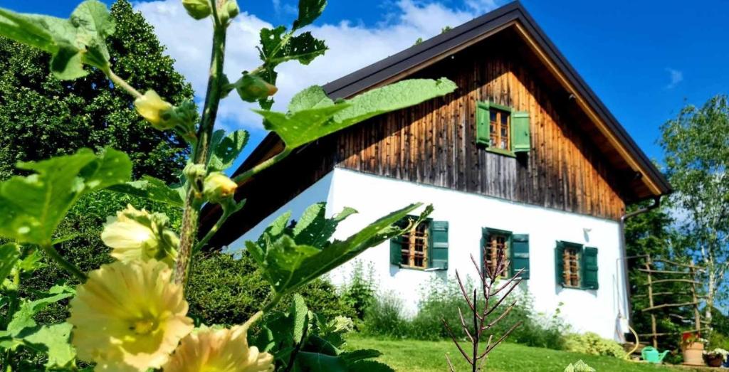 a cottage with flowers in front of it at Estate Ana in Ptuj