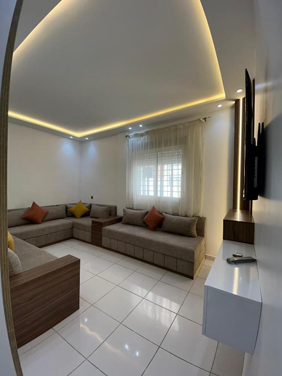 a living room with a couch and a window at Sable d'or in Tangier