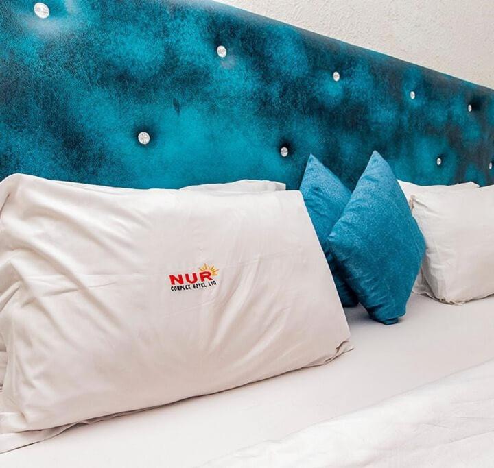 Postel nebo postele na pokoji v ubytování Nur Complex Hotel & Apartment