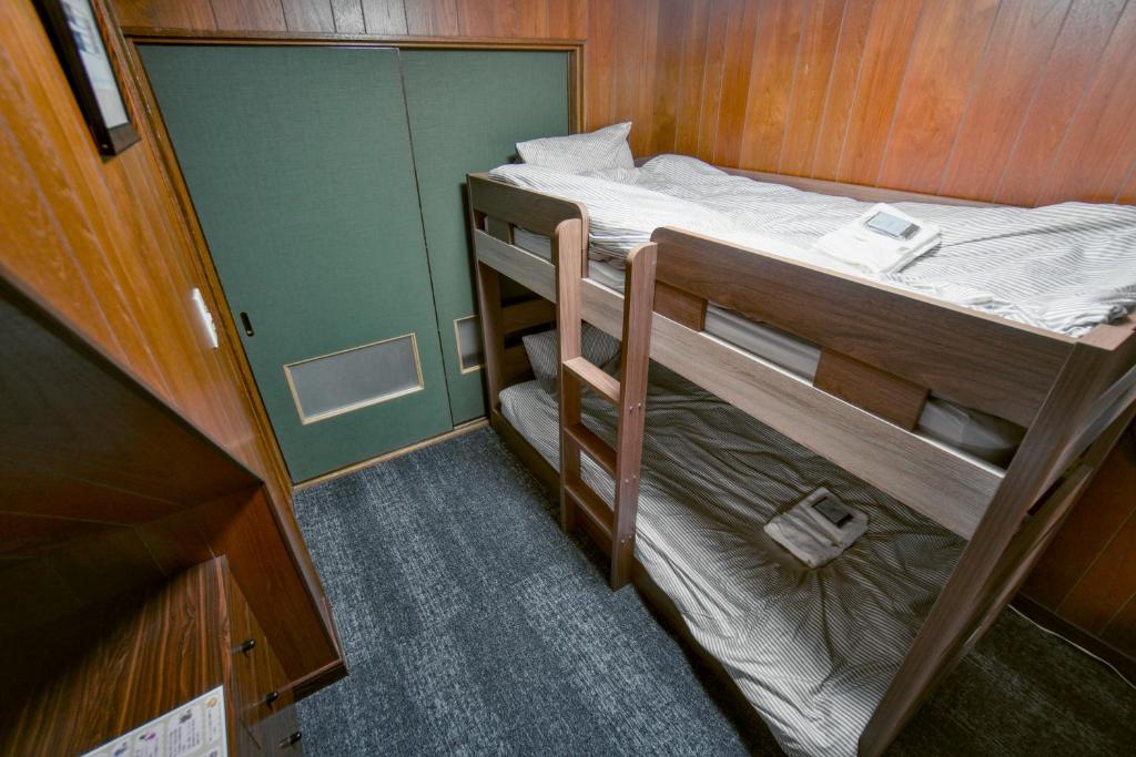 Postel nebo postele na pokoji v ubytování Guest House平安