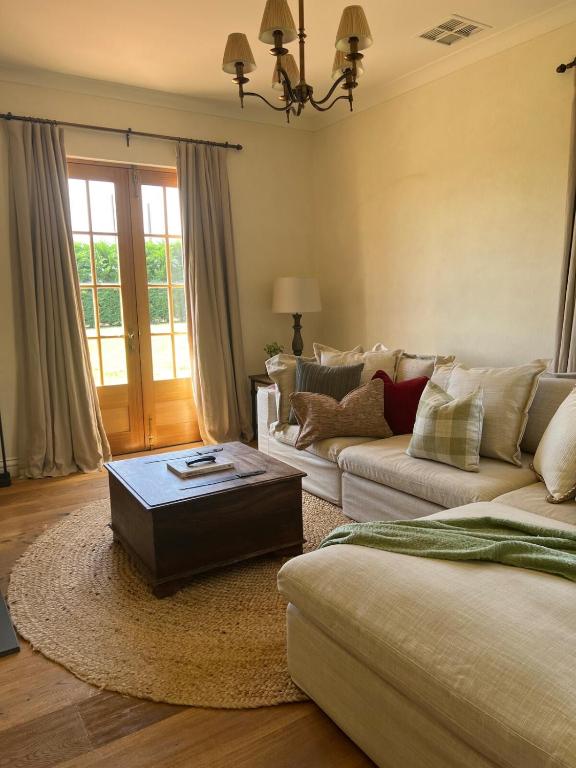 a living room with two couches and a coffee table at Ciel House - French style in Angaston